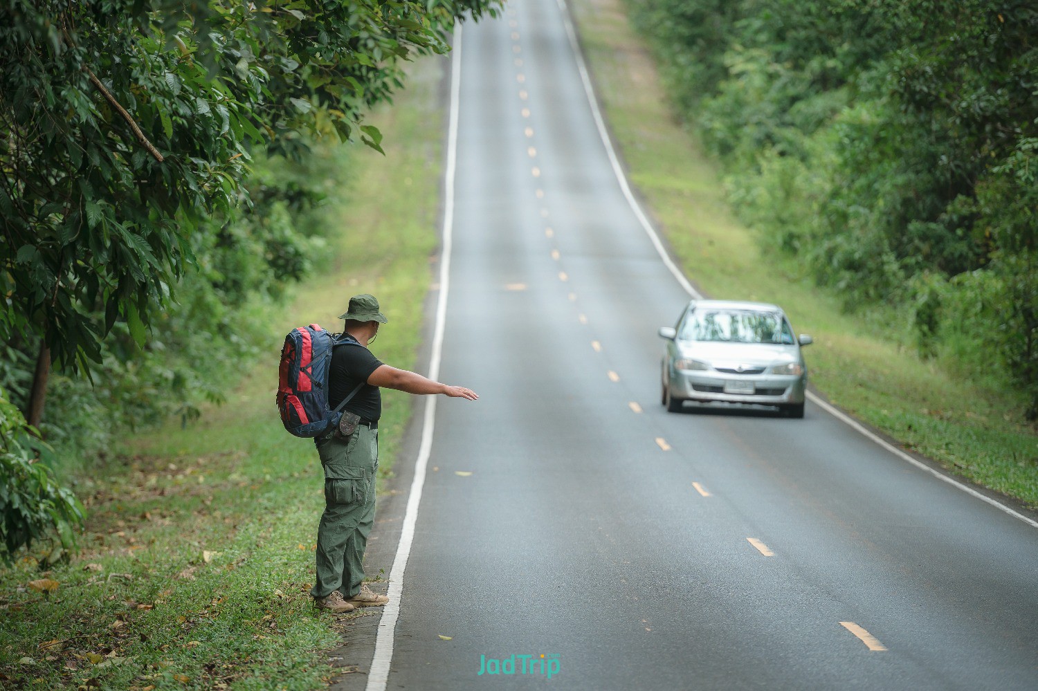 young-male-tourists-carrying-backpack-travel-by-hitchhiking-travel-by-hitchhikin.jpg