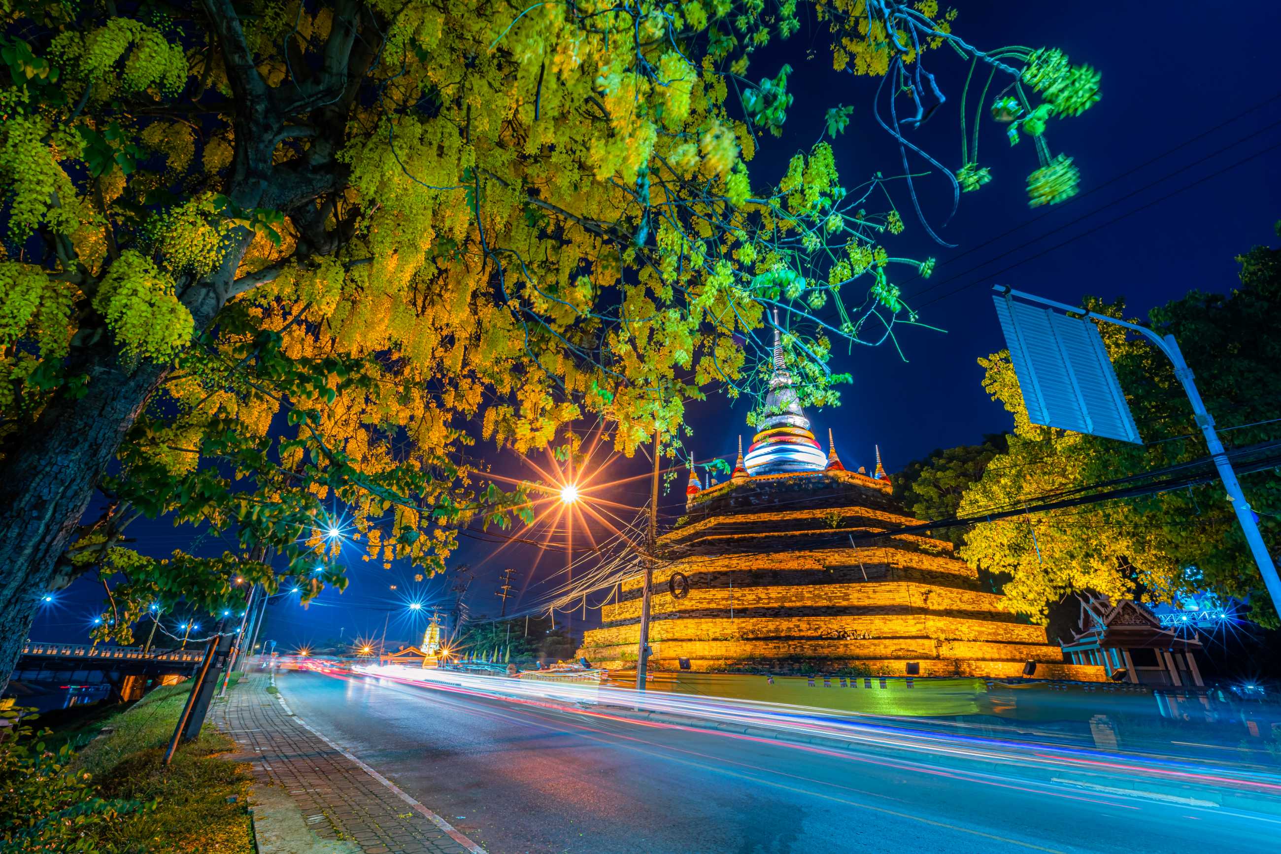 beautiful-lights-road-with-yellow-flowers-cassia-fistula-park-phra-chedi-luang-t.jpg