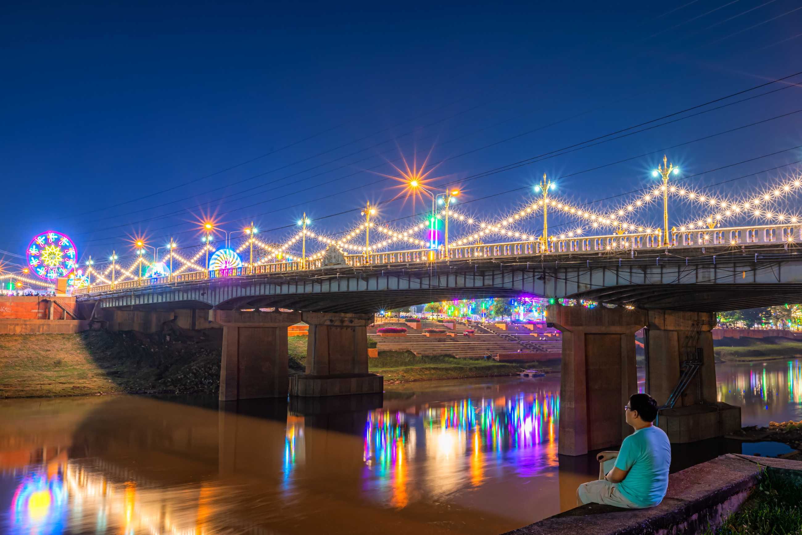 young-man-looking-beautiful-light-nan-river-night-bridge-naresuan-bridge-realm-n.jpg